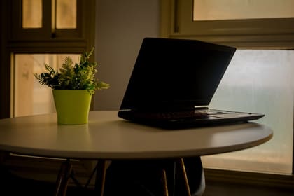 A laptop on a round table in warm evening light at Blooms