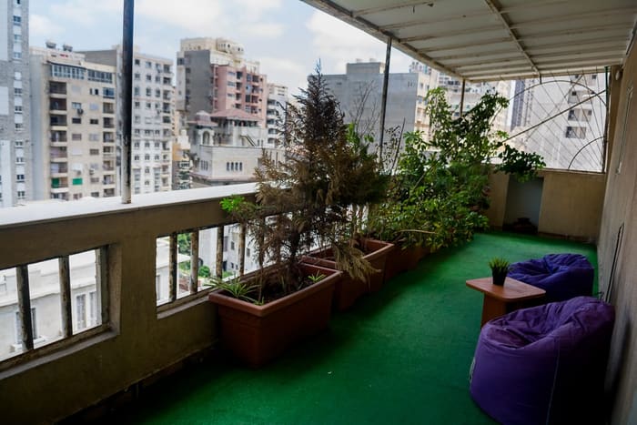 The outdoor terrace at Blooms with planters, artificial lawn and beanbag seating