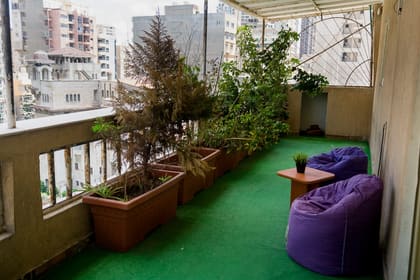 The Blooms terrace overlooking the Roushdy skyline with planters and beanbag seating